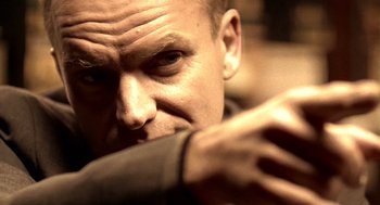 Movie still from “Lock, Stock and Two Smoking Barrels” (1998), directed by Guy Ritchie – A person with his hand on his face; Close Up shot, Low angle
