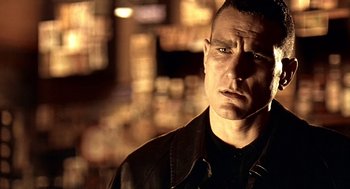 Movie still from “Lock, Stock and Two Smoking Barrels” (1998), directed by Guy Ritchie – A person wearing a leather jacket; Close Up shot, Low angle
