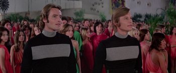 Movie still from “Logan's Run” (1976), directed by Michael Anderson – A group of people standing next to each other in a room; Medium shot, Low angle