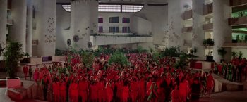 Movie still from “Logan's Run” (1976), directed by Michael Anderson – A large group of people in red uniforms; Extreme Wide shot, High angle