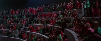 Movie still from “Logan's Run” (1976), directed by Michael Anderson – A group of people sitting in rows on a stage; Extreme Wide shot, High angle