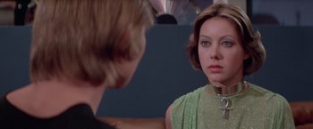 Movie still from “Logan's Run” (1976), directed by Michael Anderson – A woman looking into a mirror while a man looks at her face; Close Up shot, Over the shoulder angle