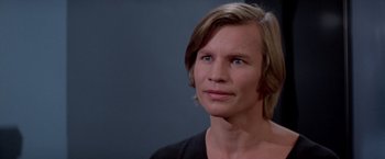 Movie still from “Logan's Run” (1976), directed by Michael Anderson – A person with long brown hair; Close Up shot, Low angle