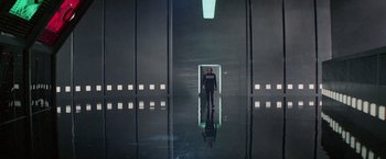 Movie still from “Logan's Run” (1976), directed by Michael Anderson – A man standing in a dark room with lights on; Extreme Wide shot, Low angle