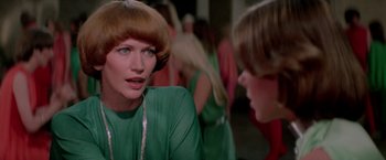 Movie still from “Logan's Run” (1976), directed by Michael Anderson – A woman in a green dress talking to another woman in a green dress; Close Up shot, Over the shoulder angle