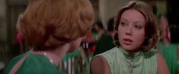 Movie still from “Logan's Run” (1976), directed by Michael Anderson – A woman in a green shirt is talking to another woman in a green dress; Close Up shot, Over the shoulder angle