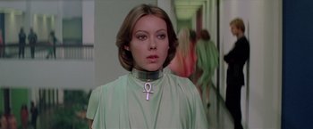 Movie still from “Logan's Run” (1976), directed by Michael Anderson – A woman wearing a green shirt and a silver collar; Close Up shot, Low angle