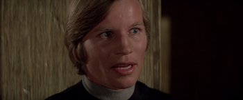 Movie still from “Logan's Run” (1976), directed by Michael Anderson – A person with long blonde hair; Close Up shot, Low angle