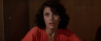 Movie still from “Logan's Run” (1976), directed by Michael Anderson – A person wearing a red shirt; Close Up shot, High angle