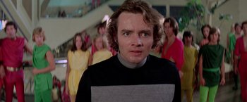 Movie still from “Logan's Run” (1976), directed by Michael Anderson – A young man in front of a group of young people; Close Up shot, Low angle