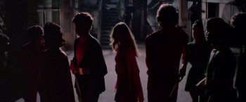 Movie still from “Logan's Run” (1976), directed by Michael Anderson – A group of people walking down a dark hallway; Medium shot, Over the shoulder angle