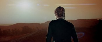 Movie still from “Logan's Run” (1976), directed by Michael Anderson – A man standing in front of a large window; Wide shot, Low angle