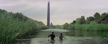 Movie still from “Logan's Run” (1976), directed by Michael Anderson – Two people swimming in a body of water near the washington monument; Wide shot, Low angle