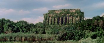 Movie still from “Logan's Run” (1976), directed by Michael Anderson – A very large rock wall covered in plants; Extreme Wide shot, Low angle