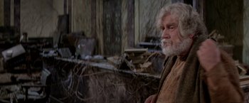 Movie still from “Logan's Run” (1976), directed by Michael Anderson – An old man with a beard and a white beard; Medium shot, Low angle