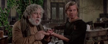 Movie still from “Logan's Run” (1976), directed by Michael Anderson – A man and a woman holding hands in a room; Medium shot, Over the shoulder angle