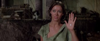 Movie still from “Logan's Run” (1976), directed by Michael Anderson – A woman in a green shirt is holding her hand up to her face; Close Up shot, Low angle
