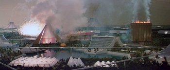 Movie still from “Logan's Run” (1976), directed by Michael Anderson – An aerial view of an amusement park with smoke billowing; Extreme Wide shot, High angle