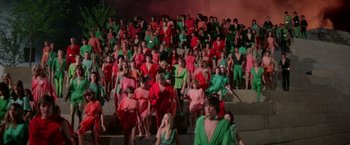 Movie still from “Logan's Run” (1976), directed by Michael Anderson – A crowd of people in red and green dresses; Extreme Wide shot, High angle