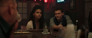 A man and a woman sitting at a table in front of each other