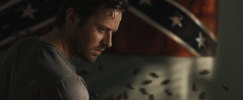 A man's face in front of an american flag
