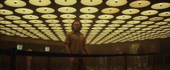 Movie still from “Loki” (2021), created by Michael Waldron – A man standing in front of a ceiling with lights; Wide shot, Low angle