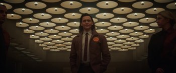 Movie still from “Loki” (2021), created by Michael Waldron – A man standing in front of a ceiling with lights; Medium shot, Low angle