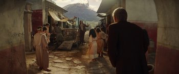Movie still from “Loki” (2021), created by Michael Waldron – A group of people standing on the side of a street; Wide shot, Over the shoulder angle