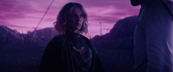 Movie still from “Loki” (2021), created by Michael Waldron – A woman standing in front of a purple sky; Medium shot, Over the shoulder angle