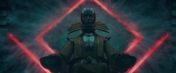 Movie still from “Loki” (2021), created by Michael Waldron – An image of a person in a costume; Medium shot, Low angle