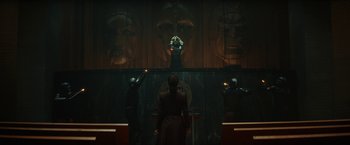 Movie still from “Loki” (2021), created by Michael Waldron – A group of people standing in front of a wall; Wide shot, Low angle