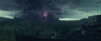 Movie still from “Loki” (2021), created by Michael Waldron – People are standing on a fence looking at a storm; Extreme Wide shot, High angle