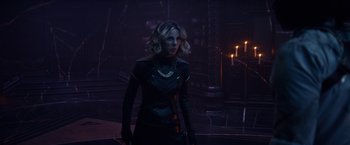 Movie still from “Loki” (2021), created by Michael Waldron – A woman in a black outfit standing in a dark room; Medium shot, Over the shoulder angle