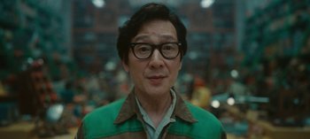 Movie still from “Loki” (2021), created by Michael Waldron – A person wearing glasses and a jacket; Close Up shot, Low angle