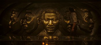 Movie still from “Loki” (2021), created by Michael Waldron – A statue of a man's face is shown in a mirror; Extreme Close Up shot, High angle