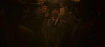 Movie still from “Loki” (2021), created by Michael Waldron – A group of people standing in a dark room; Medium shot, High angle