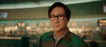 Movie still from “Loki” (2021), created by Michael Waldron – A person wearing glasses and a jacket; Close Up shot, Over the shoulder angle