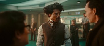 Movie still from “Loki” (2021), created by Michael Waldron – A man in a brown vest and a tie; Medium shot, Low angle