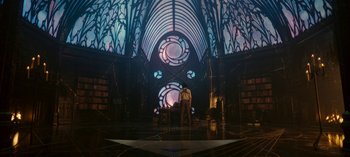 Movie still from “Loki” (2021), created by Michael Waldron – A man standing in front of a stained - glass window; Extreme Wide shot, Low angle