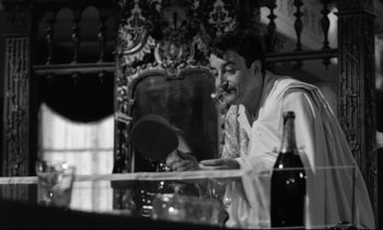 Movie still from “Lolita” (1962), directed by Stanley Kubrick – A black and white photo of a man smoking a cigarette; Close Up shot, Over the shoulder angle