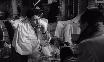 Movie still from “Lolita” (1962), directed by Stanley Kubrick – A black and white photo of a man smoking a cigarette; Medium shot, Over the shoulder angle