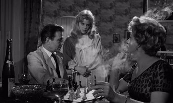 Movie still from “Lolita” (1962), directed by Stanley Kubrick – Two women and a man sitting at a table; Medium shot, Over the shoulder angle