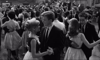 Movie still from “Lolita” (1962), directed by Stanley Kubrick – Black and white photograph of people dancing at a prom; Medium shot, Low angle