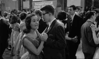 Movie still from “Lolita” (1962), directed by Stanley Kubrick – A man and a woman dancing at an event; Medium shot, High angle