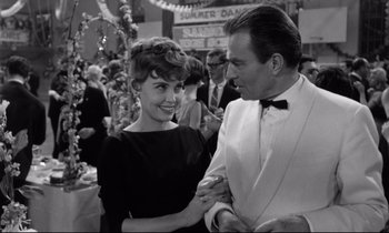 Movie still from “Lolita” (1962), directed by Stanley Kubrick – A man and a woman are smiling at each other; Medium shot, Over the shoulder angle