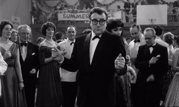 Movie still from “Lolita” (1962), directed by Stanley Kubrick – A black and white photo of a man in a tuxedo; Medium shot, Low angle