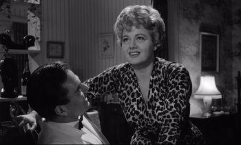 Movie still from “Lolita” (1962), directed by Stanley Kubrick – A man and a woman sitting in a room; Medium shot, Low angle