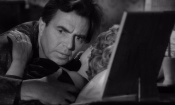 Movie still from “Lolita” (1962), directed by Stanley Kubrick – A black and white photo of a man and a woman looking at a laptop computer; Close Up shot, Low angle