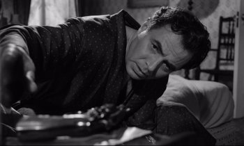 Movie still from “Lolita” (1962), directed by Stanley Kubrick – A black and white photo of a man leaning on a couch; Close Up shot, Low angle