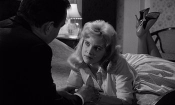 Movie still from “Lolita” (1962), directed by Stanley Kubrick – A man and a woman sitting on the floor; Medium shot, Over the shoulder angle